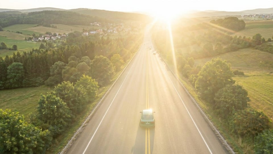 Low sun shining straight down a highway